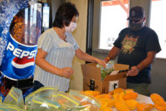 Misty Wilson assists Southern Ute tribal elder Phillip Martinez pack his string beans and squash from the Ute Mountain Ute Farm and Ranch, Monday, Aug. 10 in the Southern Ute Agriculture Building. Produce from the UMU Farm and Ranch deliveries can be picked every Friday in August at the Southern Ute Agriculture Building at 655 CR 517 in Ignacio. The Southern Ute Tribe is still under a mask advisory and social distancing is required when picking up your produce.