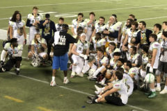 Ignacio’s Joe Garcia (front row, fifth from right) listens to post-game exhortations following Team Laulima’s 24-0 triumph over Team Lokahi at the 20201 Hawaii Tiki Bowl – played Jan. 7 inside Orlando, Florida’s Camping World Stadium, a relocation necessitated by COVID-19 precautions.