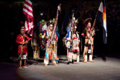 In the spotlight for the Honor Song and Flag Song, Head Dancers lead the way for Grand Entry at the 44th annual Denver March Powwow on Friday March 23, 2018.