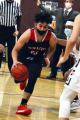 Ignacio’s Joe Garcia (23) drives around Telluride’s Tony Ordonez (right) and into the lane during SJBL road action Saturday, March 6. Garcia scored five points in the Bobcats’ 76-39 win.