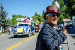Emcee Eddie Box Jr. smiles as he introduces the floats rolling through the streets of Ignacio during the 94th Annual Southern Ute Tribal Fair Parade in 2014.