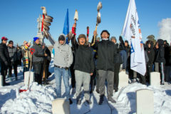 Runners from the Cheyenne and Arapaho tribes of Oklahoma raise their eagle staffs at the Riverside Cemetery in Denver before the last leg of the Sand Creek Massacre Memorial Spiritual Healing Run on Sunday, December 1, 2019. The History Colorado Center hosts an annual meal with participants and community members following the run. 