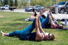 Rebecca Flinders and Danielle Burns follow SunUte Fitness Trainer Sage Frane’s lead while taking the Yoga and Breath work group exercise course at the SunUte Park on Friday, May 7. Mental health activities and events are planned for the rest of the month to highlight May as Mental Health Awareness Month. 