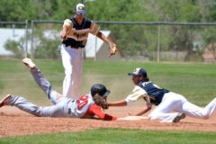 After initially sliding past the bag on a successful steal attempt, Ignacio’s Lawrence Toledo (20) just gets underneath the tag of Olathe’s Bryson Inda (11) while stretching back to second base during the first game of a June 12 road doubleheader at the Pirates’ Hubbard Field.