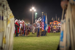 Tribal veterans and chiefs carry in the flags during Grand Entry at the 31st annual Oklahoma Indian Nation Powwow on Saturday, July 31.  

 