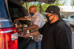Food Distribution Specialist, Edward Box III helps Stock Clerk, Bradlin Goodtracks load CARES Food Packages into vehicles on Tuesday, Sept. 21. Food packages included grains, rice and dairy products.  