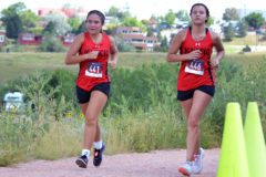 Ignacio’s Laci Brunson (441) and Harmony Reynolds (446) ran in tandem for most of the Cheyenne Mountain Stampede Friday afternoon, Sept. 3, in Colorado Springs. Both had played varsity-level volleyball against Montezuma-Cortez inside IHS Gymnasium just the night before.