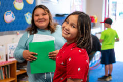Jada and Somer Cloud share a smile while they make their way through the Ignacio Elementary School hallways during the “Back 2 School and Meet-Your-Teacher Party.” 