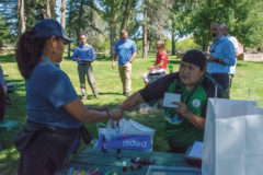 Southern Ute tribal elder, Carol Baker holds the raffle bag for Precious Collins while she picks out a winner of a Subway gift card at the Music in the Park event at Ute Park on Wednesday, Sept. 15.  