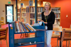 Southern Ute Cultural Center and Museum Director, Susan Cimburek organizes books in the new cultural library during the open house on Wednesday, Sept. 15.  