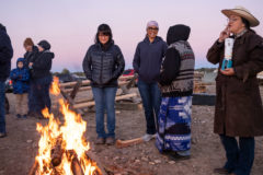 Southern Ute Councilmember Vanessa Torres warms up by the Sunrise Ceremony campfire ahead of the field dressing workshop, she was joined by members of the Southern Ute Wildlife Advisory Board on Saturday, Oct. 16. 