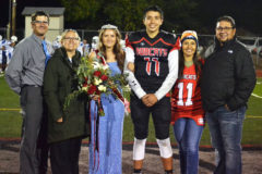 Ignacio High School 2021 Homecoming King, Gabe Tucson (11) and Queen, Alannah Gomez, both seniors, stand centered between their respective parents after being announced during halftime of the Bobcats' Oct. 8 home football game versus Center.