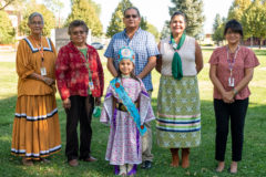 Southern Ute Tribal Council members: Linda Baker, Ramona Eagle, Chairman Melvin Baker, Stacey Oberly and Vanessa Torres stand behind Little Miss Southern Ute Royalty Representative, Shayne White Thunder in Veterans Memorial Park on Friday, Sept. 24. Tribal Council and White Thunder went to visit students during the school day at the Southern Ute Indian Montessori Academy.  