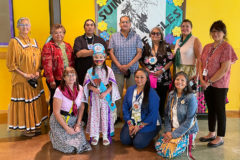 Outgoing Little Miss Southern Ute, Shayne White Thunder, took time out of her responsibilities to enjoy some traditional songs and stories at SUIMA. She is seen here with Council Member Linda Baker, Council Member Ramona Eagle, UMU Council Member Afrem Wall, Chairman Melvin Baker, UMU Council Member Betty Howe, Council Member Dr. Oberly, Council Member Torres, SUIMA Principal Mari Jo Owens, Ute Language Specialist Daisy Blue Star, and Ute Language teacher Shawna Steffler.