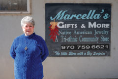 Marcella Quintana, owner of Marcella’s Gifts and More, a tri-ethnic community store stands for a portrait before her store front sign is removed from the Goodard building location on Monday, Nov. 8. 