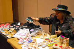 Southern Ute tribal elder, Pearl Casias holds a pair of shoes she beaded for one of her grandchildren. Pearl spoke of the origins of some of her moccasins, including a pair of well-worn youth moccasins from the Sioux tribe. 