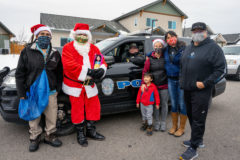Edward Box III reprises the role of Santa Clause while delivering toys to the local community, Thursday, Dec. 23. Box is on the BGC Board of Directors, joining him are Robin Duffy-Wirth and Nathan Strong Elk — also members of the BGC Board of Directors. 
