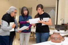 Poeh Cultural Center staff and delegates traveled to NMAI’s Cultural Resources Center, December 13-15, 2017, to review pots selected for loan to the Poeh in 2018. This work was part of the community loans partnership between NMAI and the Poeh Cultural Center, owned and operated by the Pueblo of Pojoaque in New Mexico. From left to right: Tessie Naranjo (Santa Clara), Community Representative, Poeh Cultural Center; Cynthia Chavez Lamar, (San Felipe Pueblo/Hopi/ Tewa/Navajo), Assistant Director for Collections, NMAI; and Tazbah Gaussoin, (Picuris Pueblo, Diné, French), Museum Specialist, NMAI.