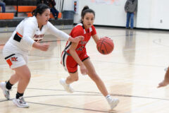 Ignacio’s Avaleena Nanaeto (35) speeds around 3A Montezuma-Cortez’s Taiah Wilson (32) on a drive into the paint during non-league action Wed., Feb. 16, at M-CHS.  Coming off a 17-point performance in the previous night’s road win at non-league 2A Del Norte, Nanaeto netted 11 points but the Lady Bobcats fell 66-64 in overtime.