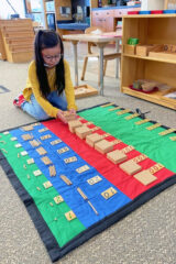 Malia White Thunder is working hard on her Montessori work, titled “the 49 layout.”