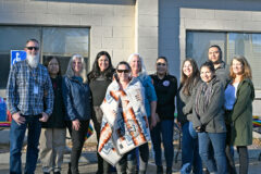 Public Education Teacher Dorian Romero stands with the Southern Ute Education Department staff on Wednesday, March 3, at the Southern Ute Education Building during Romero’s farewell event. After light refreshments, the celebration is concluded with gifts from staff, which included a Pendleton blanket in honor of Romero’s years of service to the Tribe, community, and school district.  

 