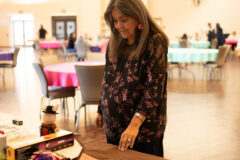 Tribal elder Luana Herrera chooses from one of many gifts donated by staff and community members during a raffle. A cake walk followed the raffle and was joined by those in attendance.  