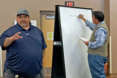 Southern Ute Lands Administration Coordinator Trainee, Wendell Vigil speaks to those in attendance at the Southern Ute Farm Assignment meeting, as Southern Ute tribal member Marvin Pinnecoose takes notes in the Southern Ute Multi-Purpose Facility, Tuesday, April 12. 