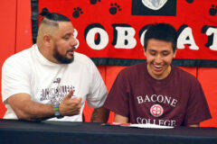 Bacone College Men's Basketball head coach Ruben Little Head, left, jokingly reminds Ignacio's Gabe Tucson that part of the Bobcat senior's National Letter-of-Intent to study at, and play for Bacone College, which includes bringing the boss coffee (with two sugars) at 8:30 each morning.  Tucson committed to the NAIA-level Warriors Thursday, May 12, inside IHS Gymnasium. 