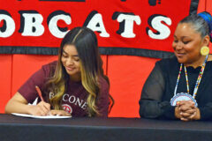 Ignacio's Elisia Cruz, left, autographs her National Letter-of-Intent to study at, and play basketball for Bacone College, Muskogee, Okla., as mother, Daisy Blue Star bears witness Thursday, May 12, inside the IHS Gymnasium. 