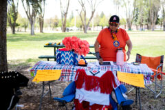 Southern Ute elder Willette Whiteskunk lies out packets of information she gathered about the Federal Boarding School Initiative Investigative Report written by the United States Department of the Interior in May of 2022 on Wednesday, May 18, at the Southern Ute Veterans Memorial Park. Whiteskunk put up a small booth in order to raise awareness on the lasting impacts and effects of historic boarding schools within Indigenous communities in North America.  