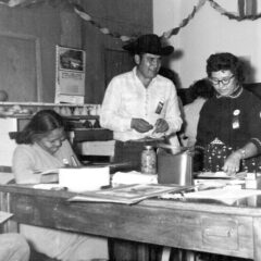 Judges of the 1960 Tribal Fair look at entries of canned goods before being put on exhibit for the community.  