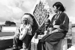 Bird and Nana Red, a respected senior tribal couple, with daughter Effie Monte, await the beginning of the annual parade on a float that won First Place in the Non-Commercial Category on Saturday, September 13, 1975.  