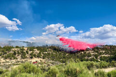 Regional air resources drop fire retardant, or slurry, on the Cox Canyon Fire located on tribal land within the Southern Ute Reservation. The fire broke out Saturday, July 9 and reached 10 acres in size prior to containment.  