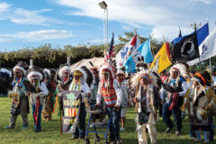 Leading the afternoon session of Grand Entry, honorable War Bonnet Society carriers enter the arena during the 4th of July Powwow in Fort Duchesne, Utah. 