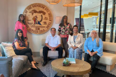 Tribal Council stands next to the ornate wooden Southern Ute Tribal Seal located in the Marriot Springhill Suites owned by the Tribe. The hotel is located in the same area as the other real estate investments.  