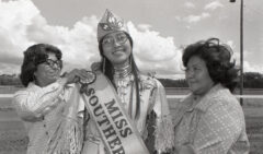 16-year-old Linda Baker was crowned Miss Southern Ute in September of 1975. Baker was assisted in pinning her sash by Margaret Mouser and Shirley Frost at the Sky Ute Downs Racetrack.  