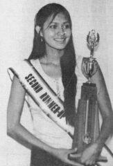 Linda Baker with the banner and trophy she won at the recent Miss Indian America Pageant in Sheridan, Wyo. She was the second runner up winner. This photo first appeared in the August 13, 1982, edition of The Southern Ute Drum.  