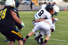 Ignacio's D.J. Hendren (8) and John Riepel (4) drop a Navajo Prep ball-carrier for a loss during interstate action Friday, Sept. 16, in Farmington, N.M. 