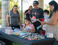 Lawrence Santisteven and family attend the Southern Ute Indian Montessori Acadamy’s open house, Thursday, Aug. 25, held in the school playground area. Southern Ute tribal departments, including the Health Clinic had tents up to provide helpful information and goodies for families.  