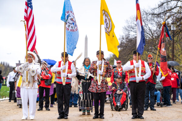 Southern Ute Veterans Association members, pictured left to right: Raymond Baker (U.S. Navy Retired), Bruce Valdez (U.S. Army), Gordon Hammond (U.S. Marines), Bruce LeClaire (U.S. Army), and Southern Ute Tribal Council member, Linda Baker (back row), march in a procession across the National Mall on Friday, Nov. 11, as part of the color guard assembled for the dedication of the National Native American Veterans Memorial in Washington, D.C.  