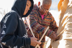 Meskvlwv Wesley, SUIMA upper elementary student helps Southern Ute elder Hanley Frost put sticks into the front door of the tipi. The demonstration provided a hands-on culture experience for the younger students at the Southern Ute Indian Montessori Academy Tuesday, Nov. 1. 