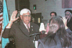 Newly elected Southern Ute Tribal Chairman Howard Richards Sr. recites the Oath of Office as administered by Tribal Court Chief Judge Elaine Newton in Rolling Thunder Hall on the morning of Dec. 17, 2002. This photo first appeared in the December 27, 2002, edition of the Southern Ute Drum.