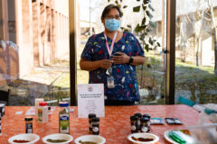 The Shining Mountain Health and Wellness division hosted a spice workshop where visitors could ask questions about spices and seasonings for all their holiday needs in the Hall of Warriors on Tuesday, Nov. 22. Shining Mountain Health and Wellness Diabetes Patient Coordinator, ShawMarie Tso talks with a tribal employee about the benefits of making your own taco seasonings as opposed to using premade seasoning packets which typically have higher salt content.  