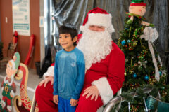 Atticus Harlan gets his picture taken with Santa Clause at the Sun Ute Recreation swimming pool. SunUte hosted Swimming with Santa for Southern Ute Indian Montessori Academy students and families, Friday, Dec. 16. 