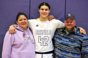 Part of Bayfield High School Boys’ Basketball’s nine-player Class of 2023, Silas Wilbourn stands proudly between father Lawrence and mother Rhonda inside BHS Gymnasium, after the Wolverines’ 50-42 win Thursday night, Jan. 19, over visiting Ignacio.