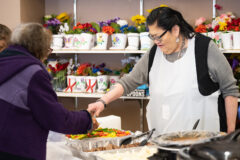 Multi-Purpose Facility Administrative Assistant, Jacqueline Frost serves tribal elder, Georgia McKinley during the monthly Sip, Chat, and Chew at the Multi-Purpose Facility on Friday, Jan. 21. Tribal members were able to get a meal, get involved in a raffle for prizes and participate in a Men’s Frybread Making contest later in the afternoon.  