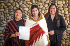 Southern Ute tribal member Diane Millich joined other Native women and tribal leaders on Thursday, March 7 to celebrate with President Obama the reauthorization of the Violence Against Women Act. Millich along with her mother, Arlene Millich (left) and her sister, Dedra White (right) – with a formal letter of appreciation and Pendleton Blanket given by the Southern Ute Indian Tribal Council in honor of her work. This photo first appeared in the March 22, 2013, edition of the Southern Ute Drum. 
