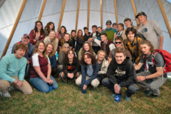 Golden High School students assemble for a photo within the SUIMA tipi. Mari Jo Owens gave a tour of the academy campus to the students. 