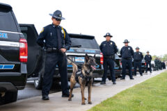 Southern Ute Police Officer, Adrian Wauneka and K-9 detecting dog, Raven line up in front of their police unit ahead of the vehicle inspection performed by Southern Ute Tribal Council on Monday, May 15 in recognition of Law Enforcement Week. A traditional blessing of law enforcement personnel and patrol vehicles was also performed by Bear Dance Chief, Matthew Box.  