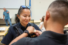 SUPD Sergeant Khaera Chee-Wauneka, having recently received a promotion within the Southern Ute Police Department, gets a new badge ceremoniously pinned to her uniform for the first time by husband, Adrian Wauneka, Friday, Aug. 18. 
 